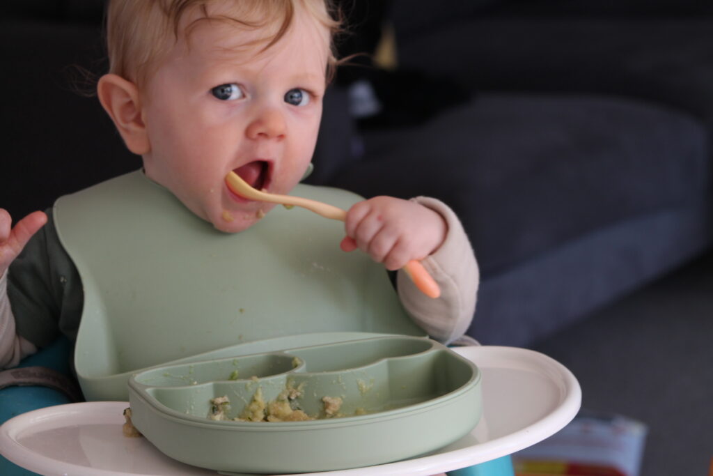 baby feeding themselves