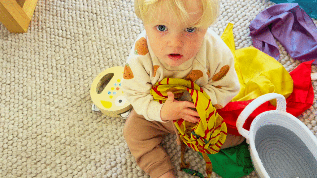toddler holding rock and silk bag