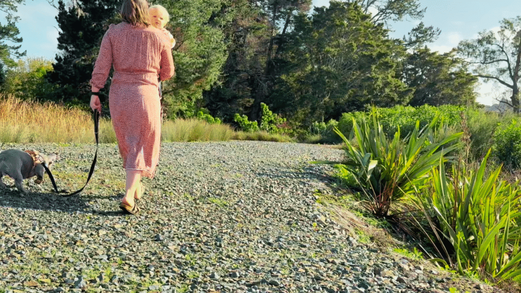 mom holding toddler and walking in nature