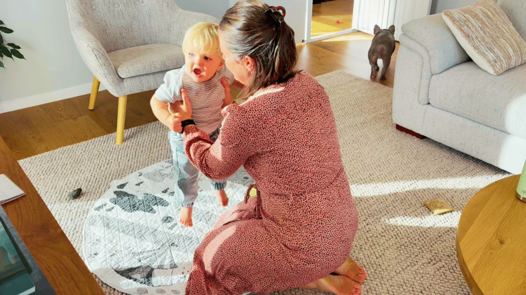 mom bouncing toddler on circle mat