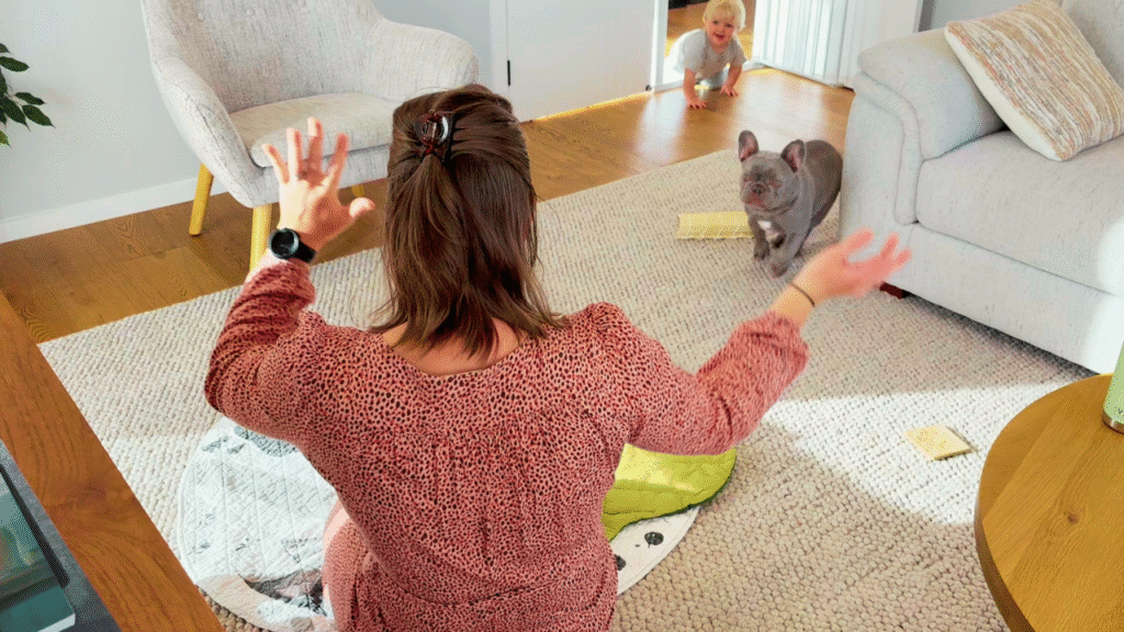 Mom on circle mat singing and dancing to toddler