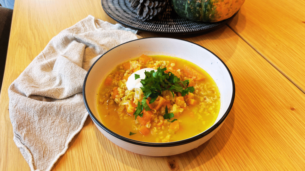 Autumn vegetable soup on wooden table