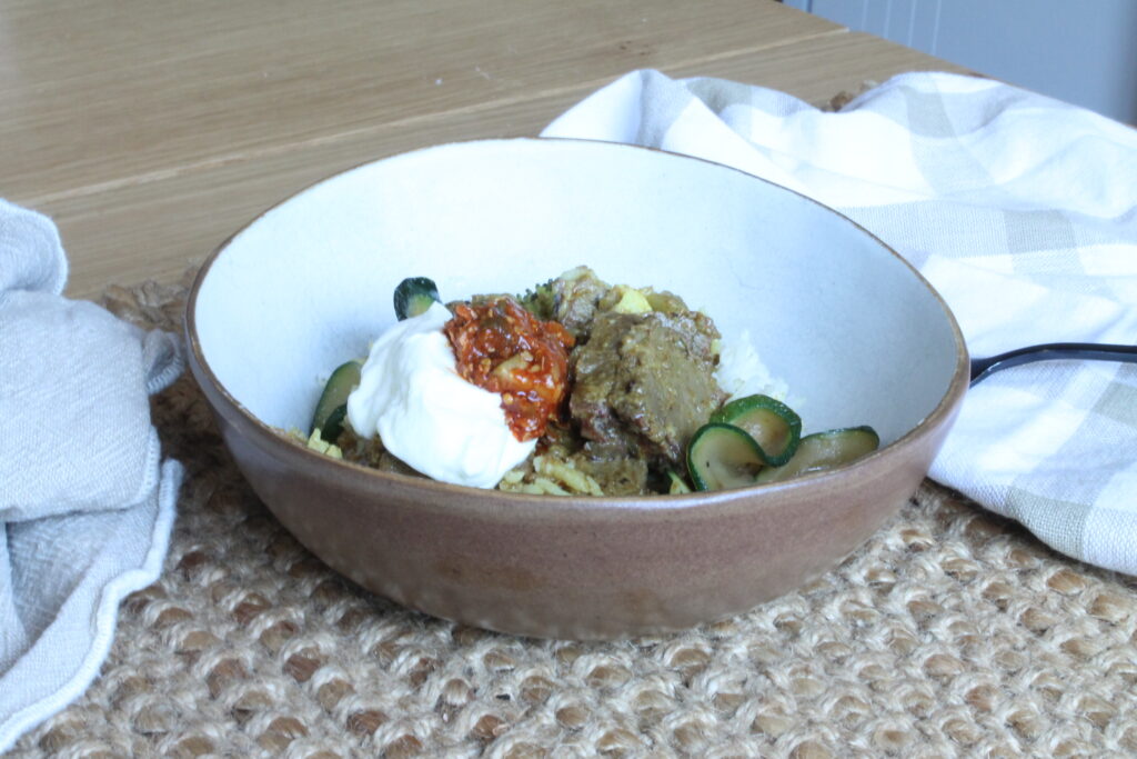 bowl of leftover slow cooked brisket curry and rice postpartum meal