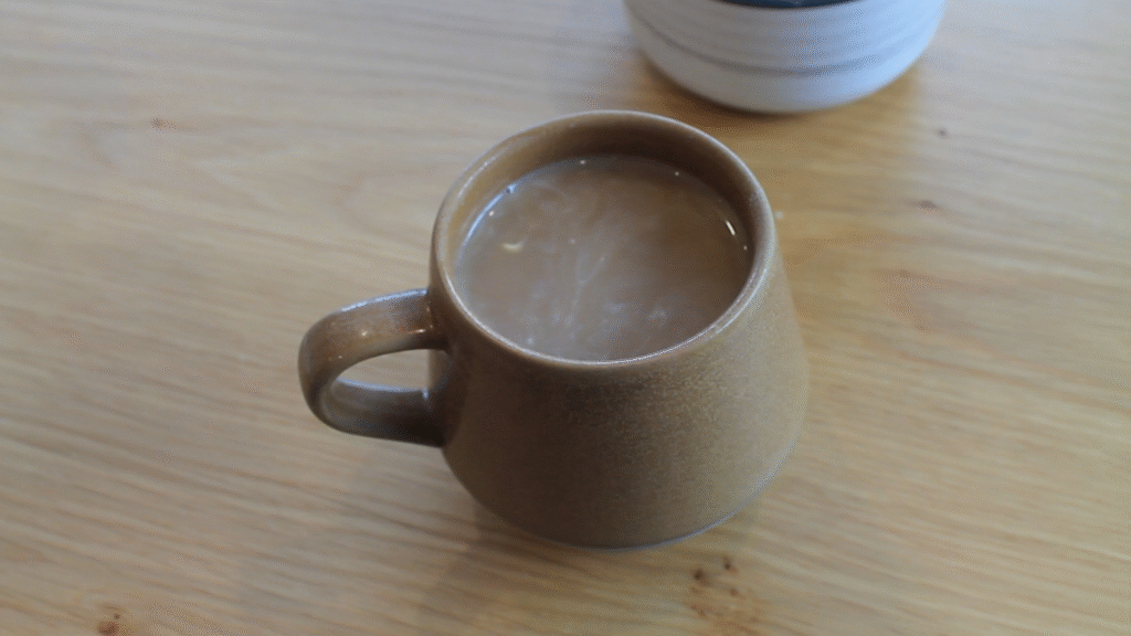 cup of white coffee on wooden table