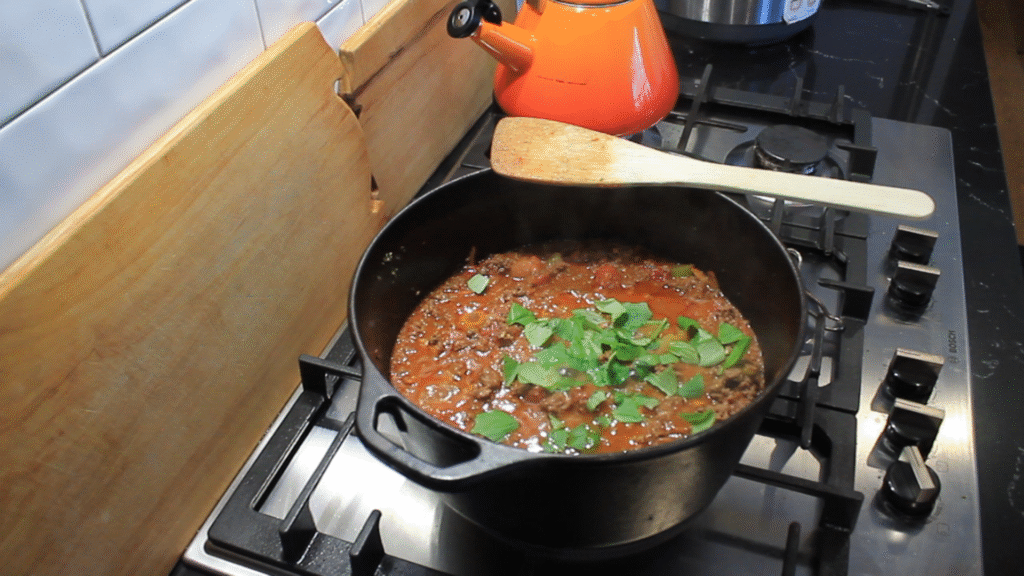 pot of meat sauce cooking for from scratch lasagna for postpartum meals
