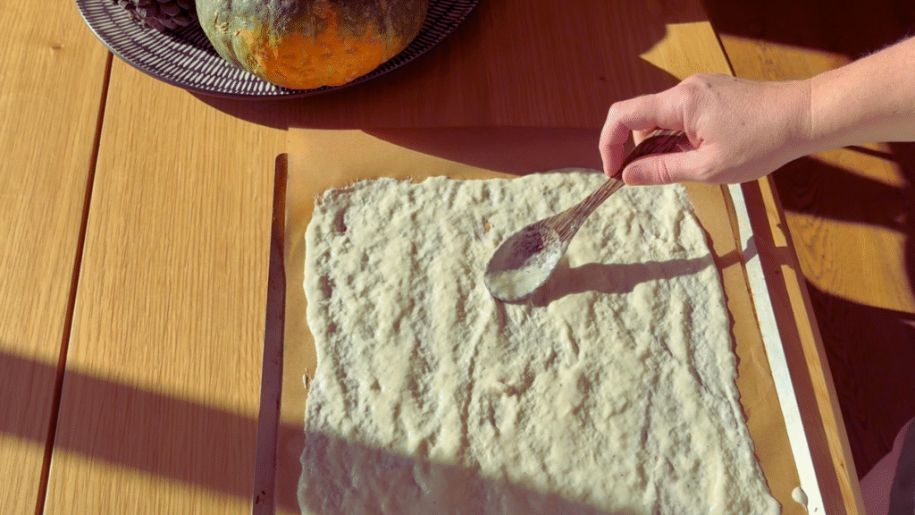 spreading sourdough cracker mixture before cooking