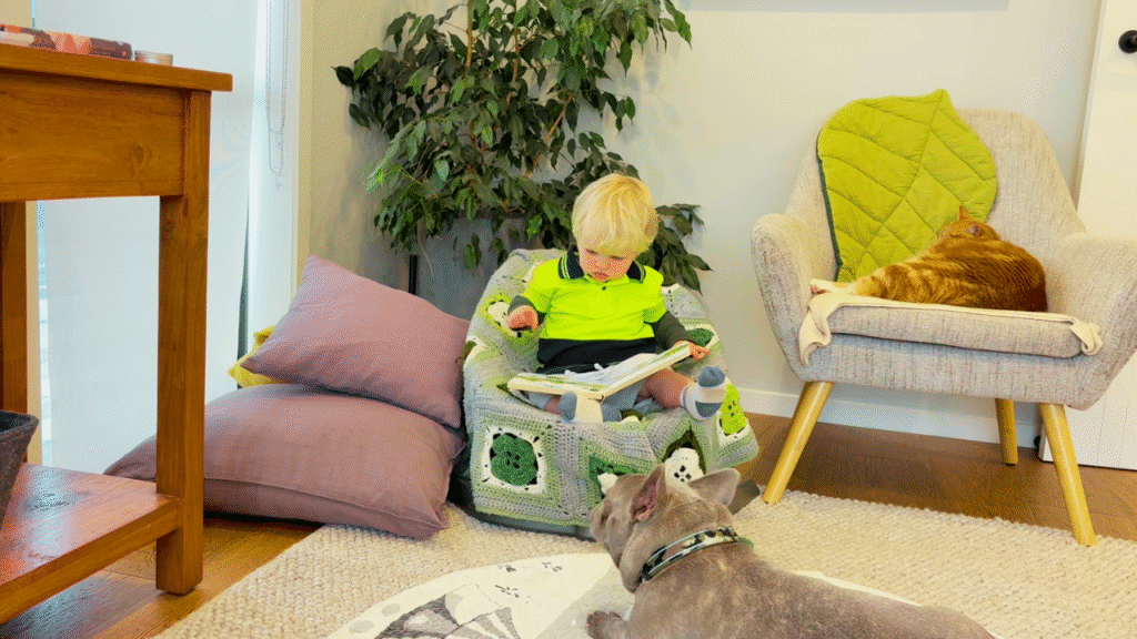 Toddler reading in spring reading nook