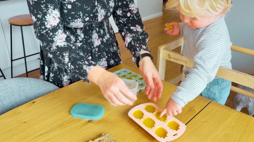 toddler helping mum with the frozen lemon juice and rind shapes