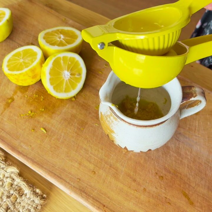 lemons being juiced to preserve into lemon juice and rind cubes