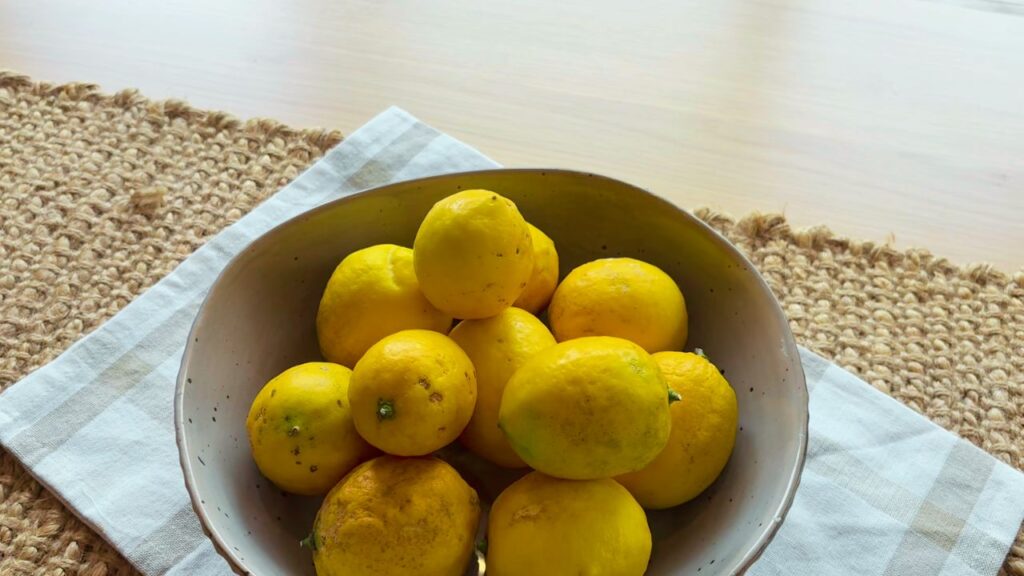 bowl of lemons on wooden table
