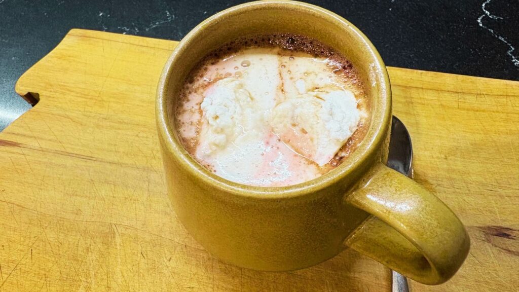 Festive hot chocoloate with low sugar marshmallows melting on the surface