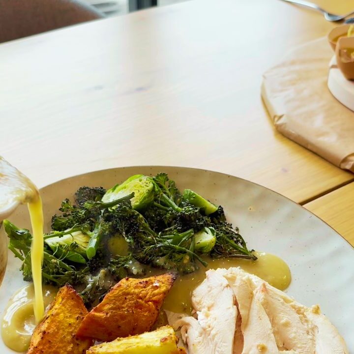from scratch gravy being poured over roast meal at the table