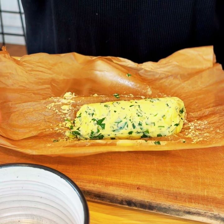 garlic and herb butter being unrolled