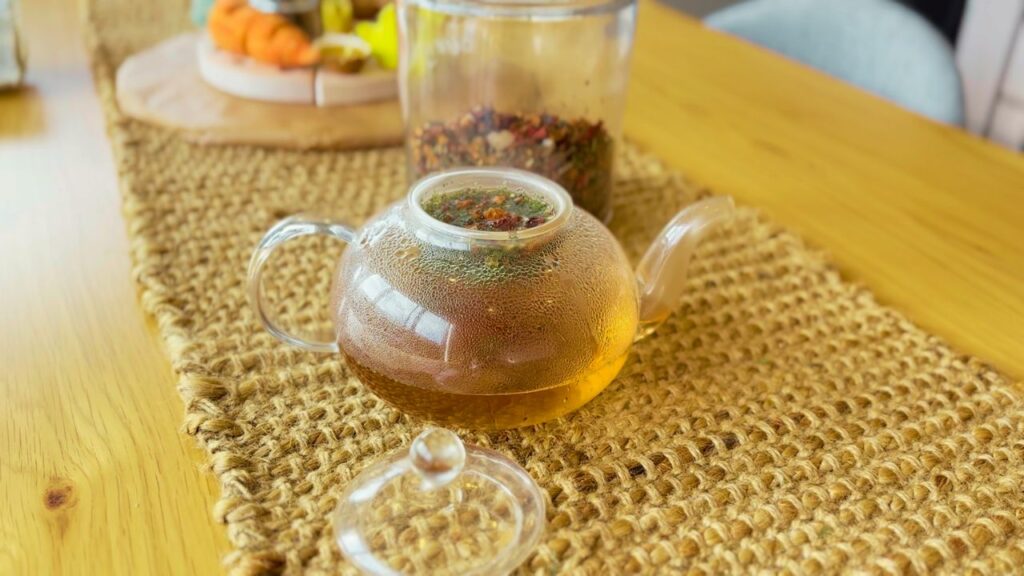 Glass teapot with herbal tea brewing