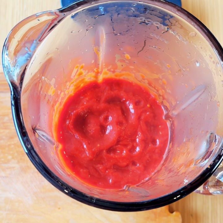 Freshly blended homemade ketchup in a blender, thick and bright red, made with real tomatoes, vinegar, and maple syrup — a seed-oil-free alternative to store-bought sauces.