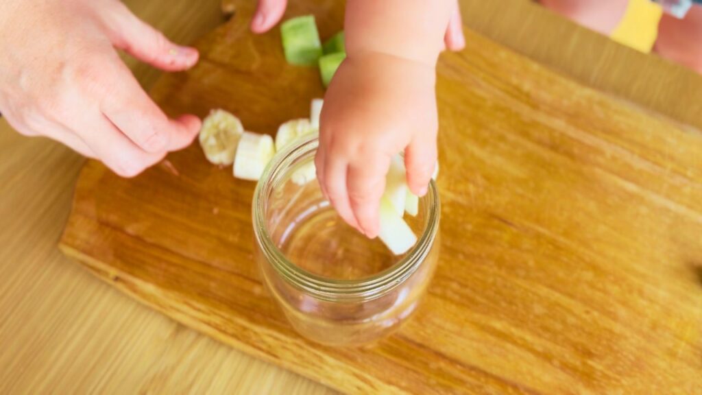 Toddler helping to prepare travel snack