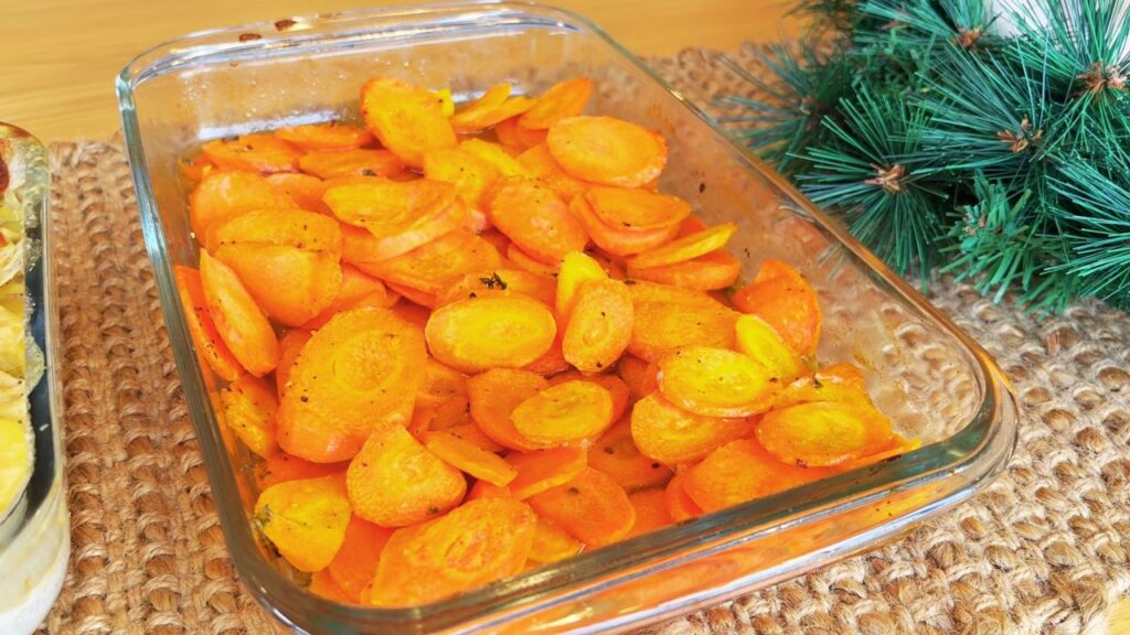 Honey–roasted carrots in a glass baking dish, one of the simple holiday side dishes prepared ahead for Christmas.