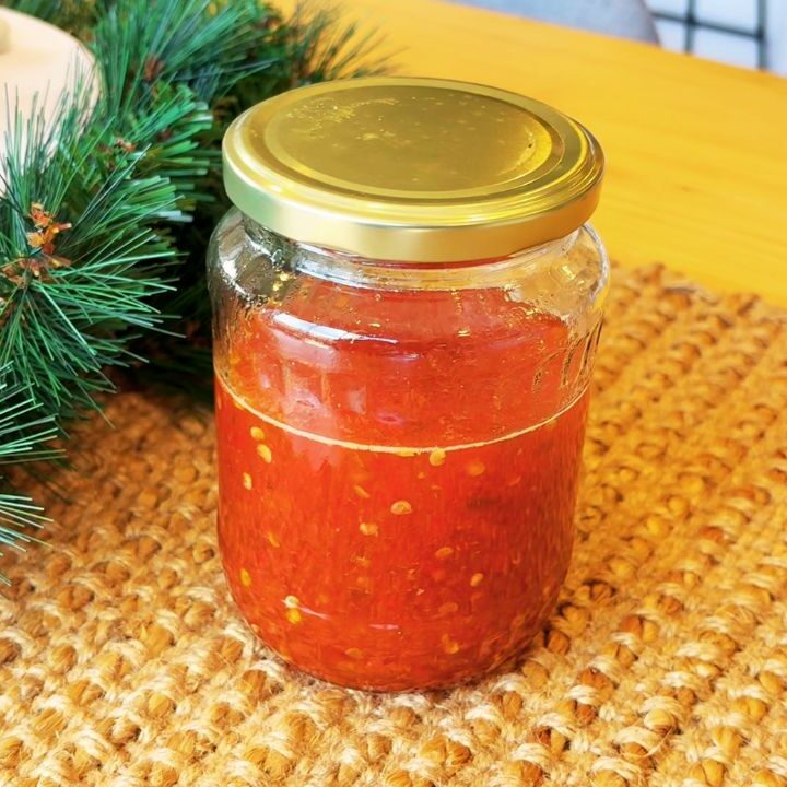 Homemade chili jam in a glass jar, a festive make-ahead condiment to serve alongside simple holiday side dishes.