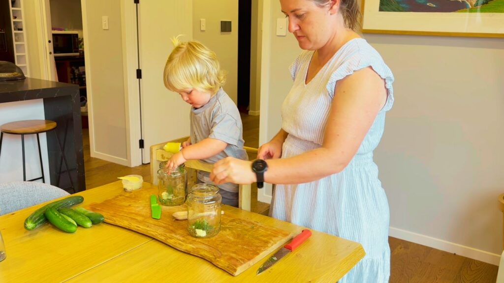 mother and toddler preparing food together in the kitchen