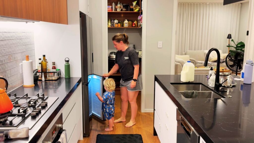 mother and toddler together in the kitchen during an everyday family moment