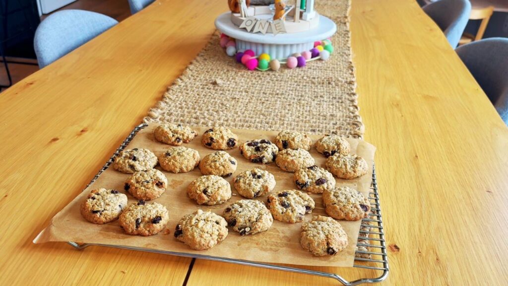 Finished oat and raisin cookies for toddlers cooling on a rack on a wooden table